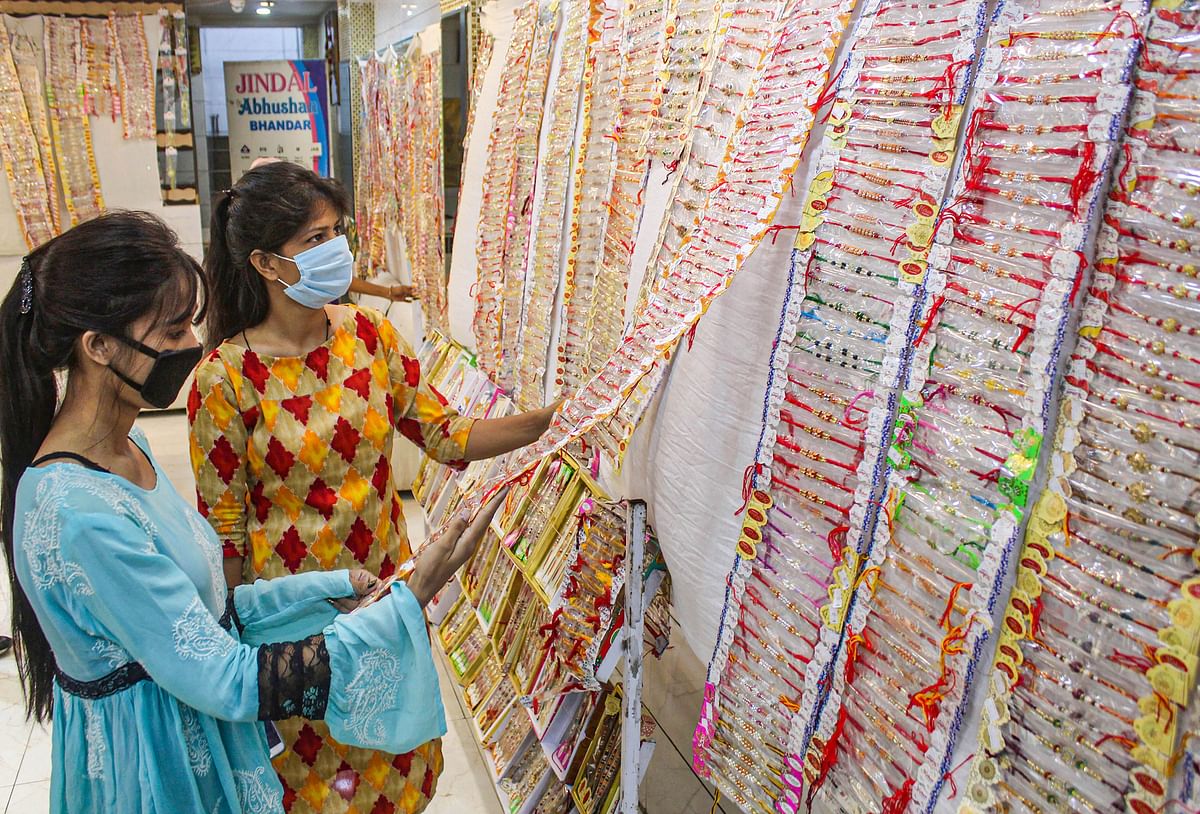 Women purchase 'rakhi' ahead of Raksha Bandhan festival at Sadar Bazaar, in Gurugram, Sunday, Aug. 2, 2020. Credit: PTI Photo