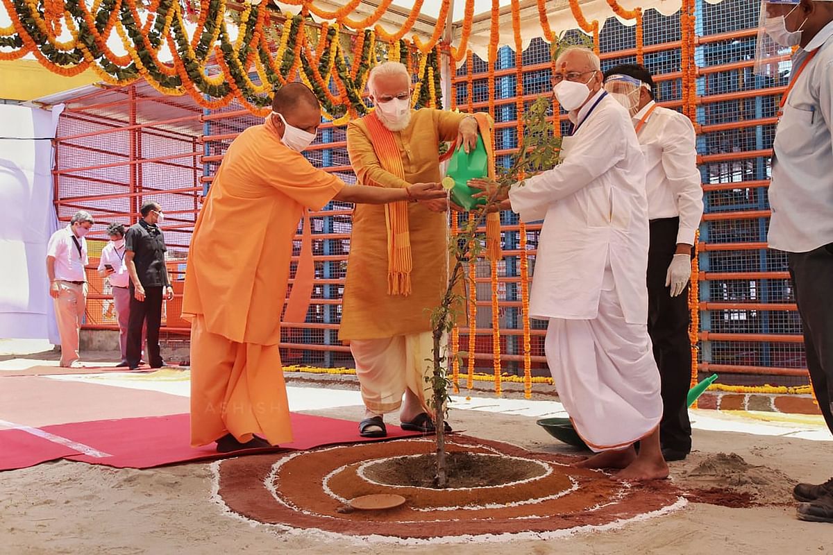 Prime Minister Narendra Modi along with Uttar Pradesh Chief Minister Yogi Adityanath waters Parijaat sapling ahead of the inception of Bhoomi Pujan. Credit: PTI