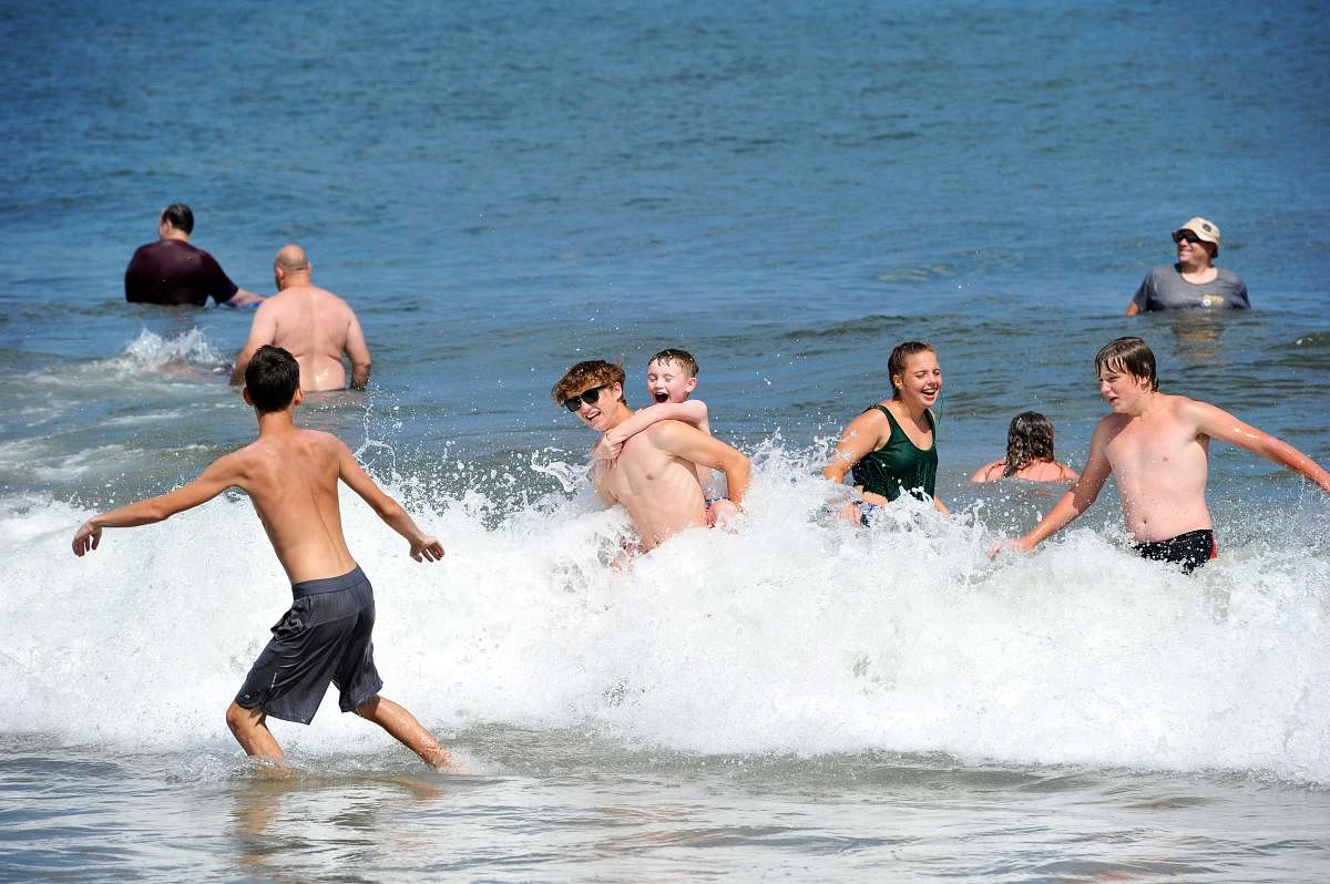 Children play in the water at Hampton Beach in Hampton, New Hampshire on August 5, 2020, as Covid-19 cases in New England are on the rise. Credit: AFP
