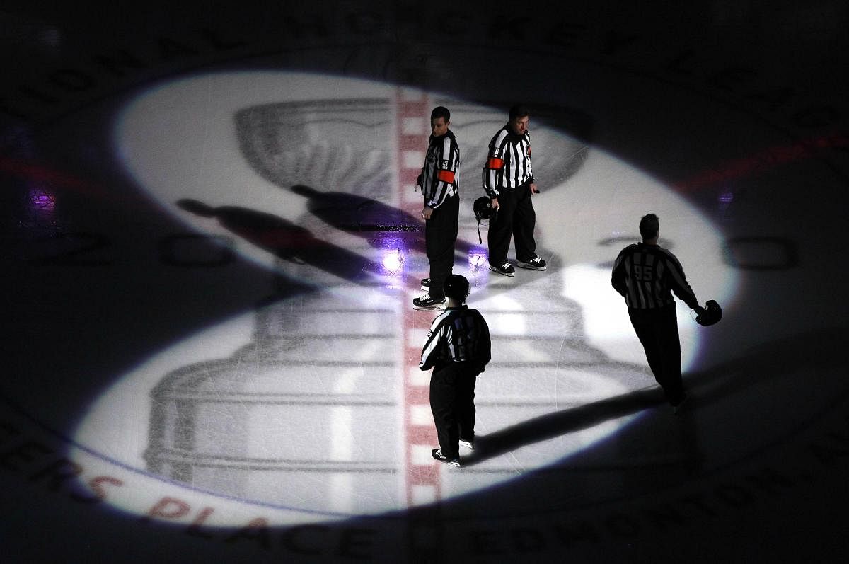 The on ice officials skate to center ice before the game between the Dallas Stars and the Colorado Avalanche in a Western Conference Round Robin game during the 2020 NHL Stanley Cup Playoff at Rogers Place, Credit: AFP