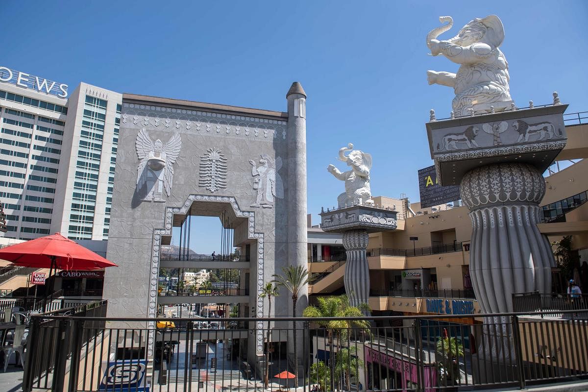 Elephant topped columns and an arch with Babylonian images framing the Hollywood sign in the distance are seen inside the Hollywood & Highland shopping center. Credit: AFP