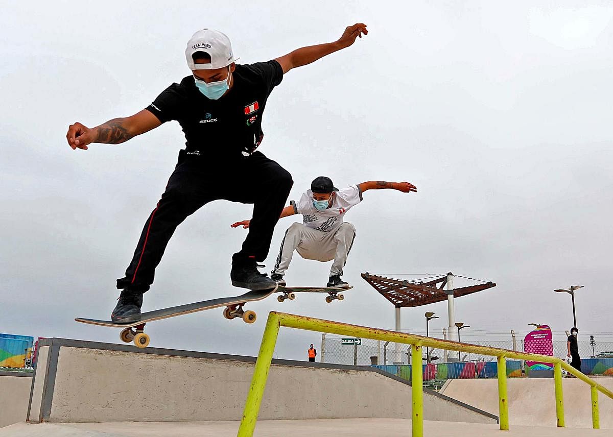 Handout picture released by the Peruvian Institute of Sports of high-performance freestyle skateboarders Marcelo Montes (L) and Arturo Fernandez during practice. Credit: AFP