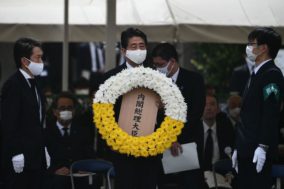 Japanese Prime Minister Shinzo Abe lays a wreath during a ceremony marking the 75th anniversary of the atomic bombing of Nagasaki, at the Nagasaki Peace Park on August 9, 2020. - Nagasaki was flattened in an atomic inferno three days after Hiroshima in 1945, twin nuclear attacks that rang in the nuclear age and gave Japan the bleak distinction of being the only country to be struck by atomic weapons. Credit: AFP