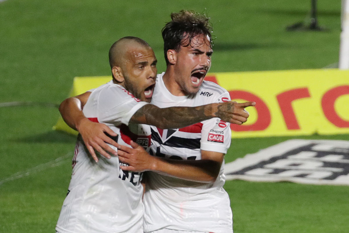 Sao Paulo's Dani Alves celebrates scoring their first goal with Igor Gomes, following the resumption of play behind closed doors after the outbreak of the coronavirus disease. Credit: Reuters