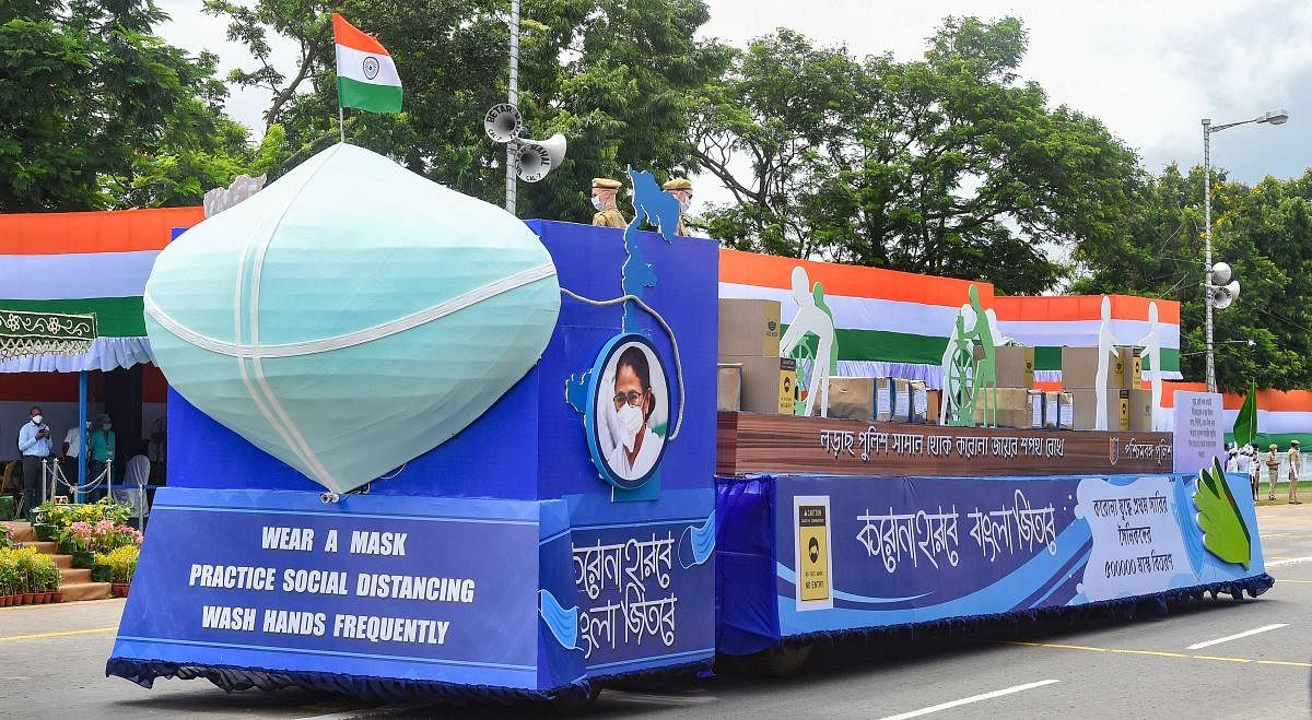 A tableau on coronavirus safety measures moves past during the 74th Independence Day function, at Red Road in Kolkata. Credit: PTI Photo