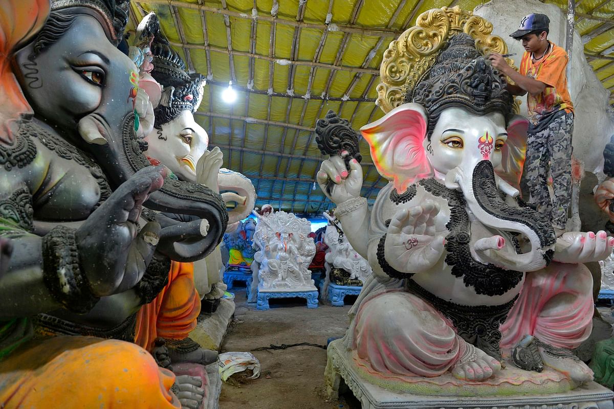 A worker cleans an idol of elephant headed Hindu god Ganesha, at a workshop ahead of the Ganesh Chaturthi festival, on the outskirts of Hyderabad. Credit: AFP