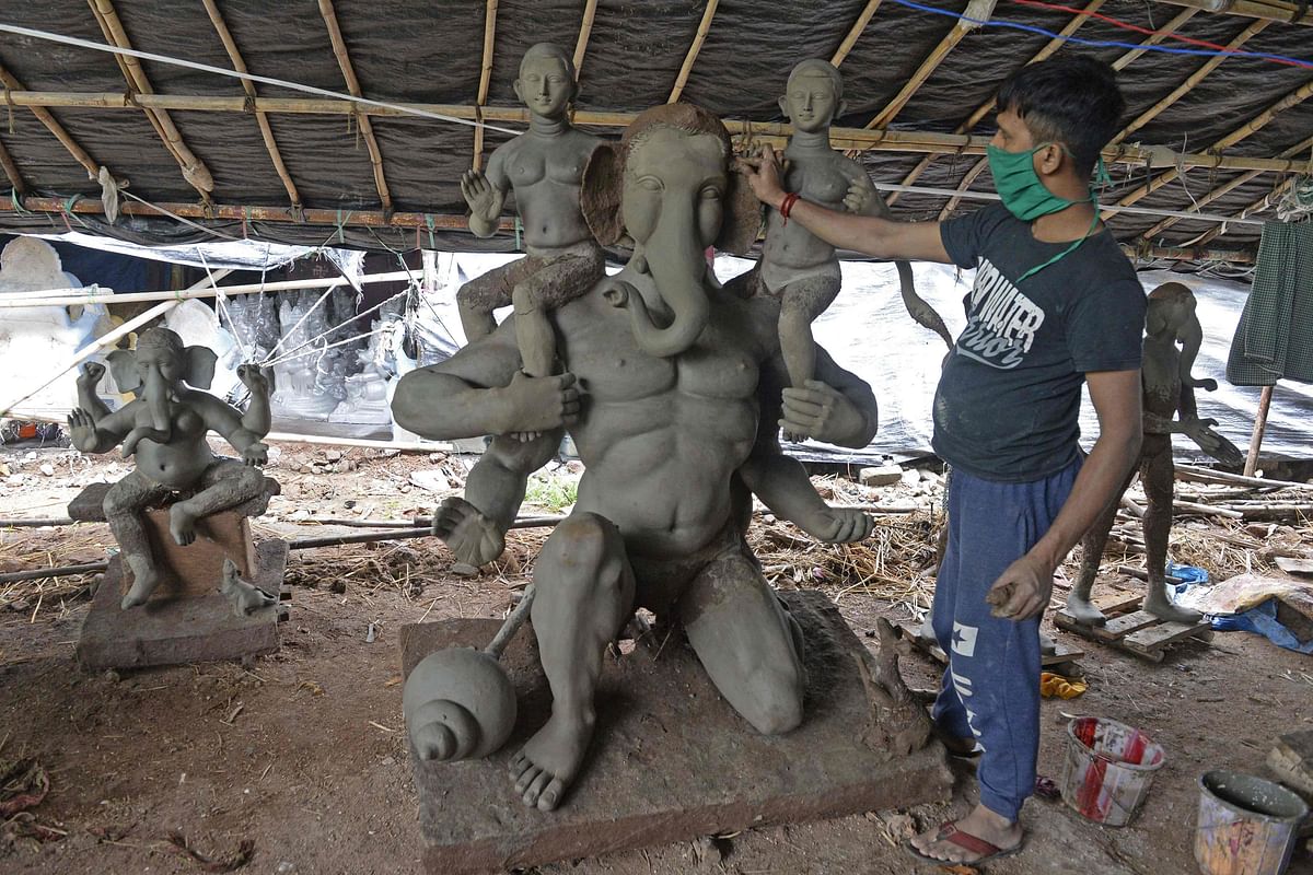 An artisan works on an idol of elephant headed Hindu god Ganesha made with mud, jute and bamboo at a workshop ahead of the Ganesh Chaturthi festival, on the outskirts of Hyderabad. Credit: AFP
