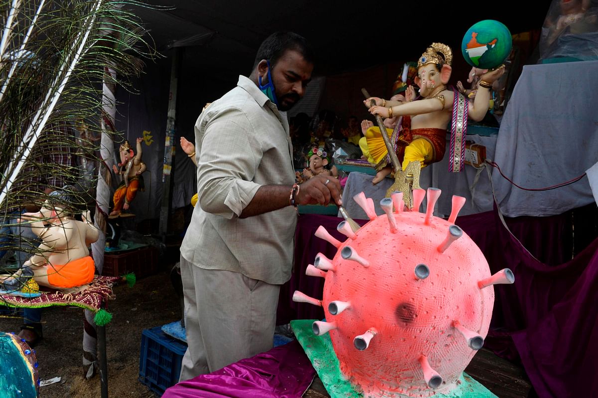 A vendor cleans an idol of COVID-19 coronavirus themed elephant headed Hindu god Ganesha at a workshop ahead of the Ganesh Chaturthi festival in Hyderabad. Credit: AFP