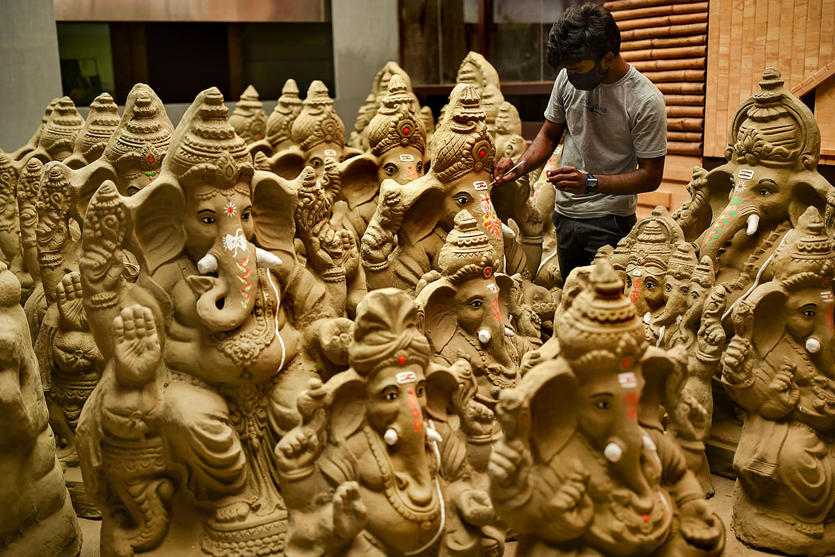 An artist gives finishing touches to idols of Lord Ganesha ahead of Ganesh Chaturthi festival, at a workshop in Vijayawada. Credit: PTI