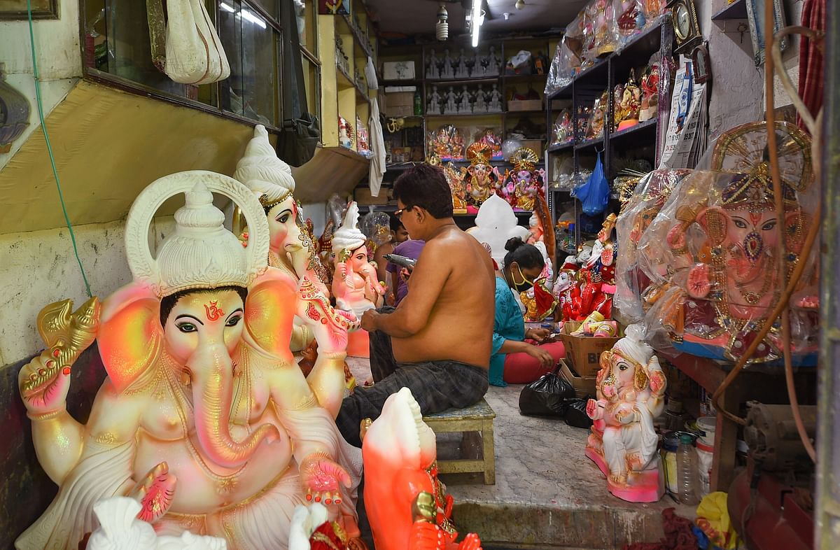 Artisans make the idols of Lord Ganesh for the upcoming Ganesh Chaturthi festival, at Kumartuli in Kolkata. Credit: PTI