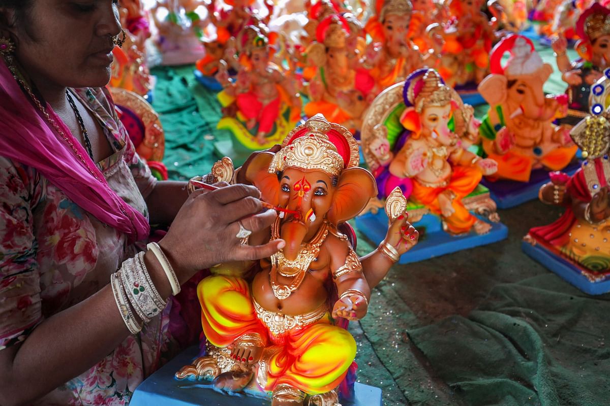 A worker cleans an idol of elephant headed Hindu god Ganesha, at a workshop ahead of the Ganesh Chaturthi festival, on the outskirts of Hyderabad. Credit: AFP