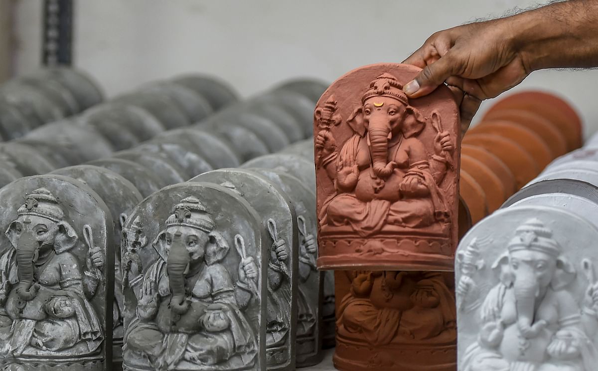 Artist Vishal Shinde (41) shows a clay idol of Lord Ganesha, made by him, ahead of the Ganesh Chaturthi festival, at his workshop in Worli, Mumbai, Wednesday, July 29, 2020. Shinde has made 200 Ganesh idols (8 inches each) that can be easily immersed at home while keeping the situation of coronavirus pandemic in mind. Credit: PTI