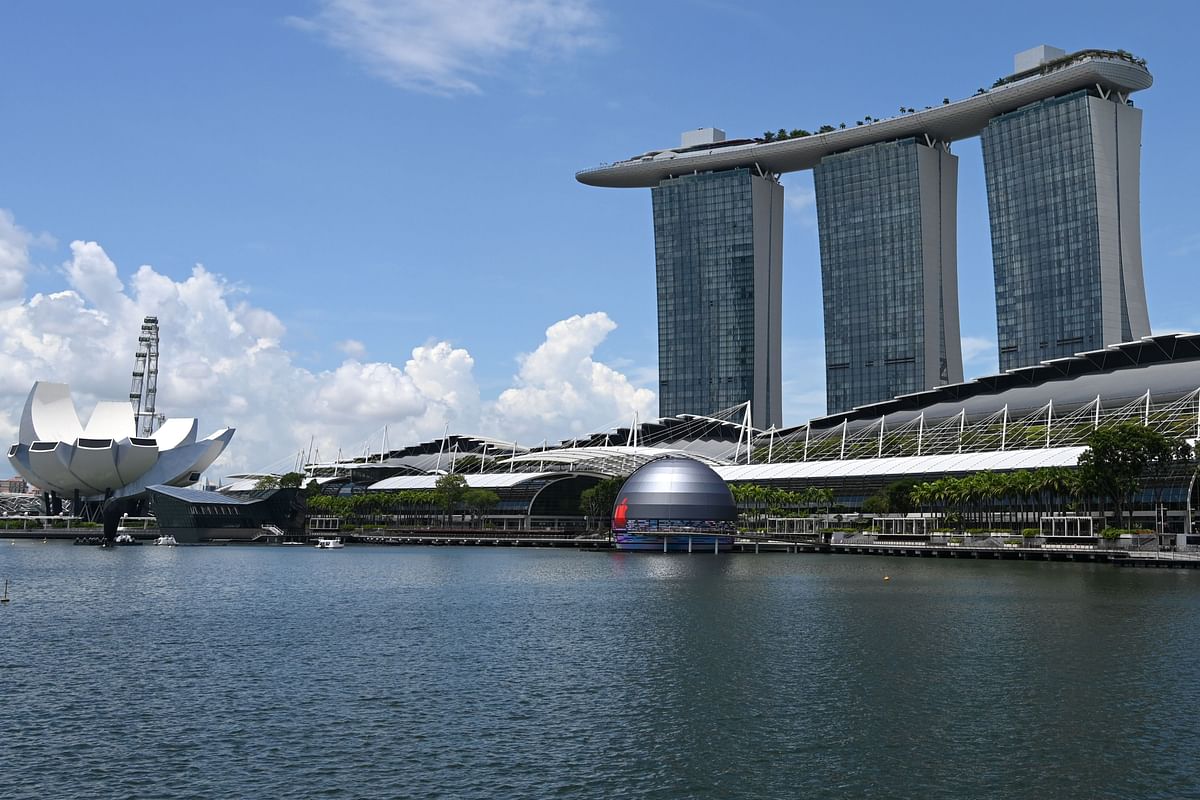 A general view shows the new Apple store (C), located in the water in front of the Marina Bay Sands, in Singapore. Credit: AFP Photo