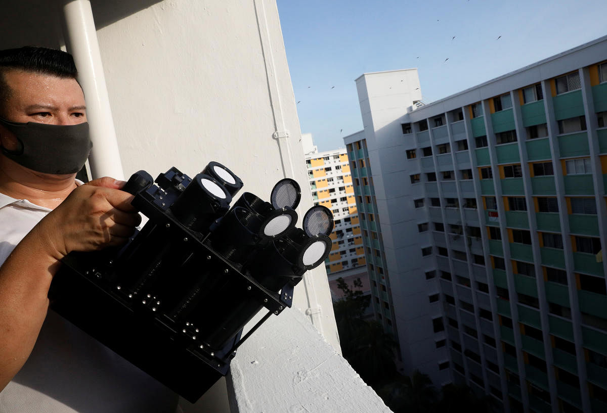 Male Wolbachia-aedes aegypti mosquitos are released via a mosquito launcher at a public housing estate test site in Singapore. Reuters