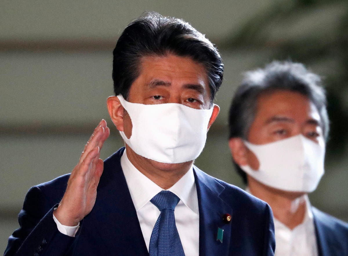 Japan's Prime Minister Shinzo Abe wearing a protective face mask arrives at his official residence, amid the coronavirus disease (Covid-19) outbreak, in Tokyo. Reuters