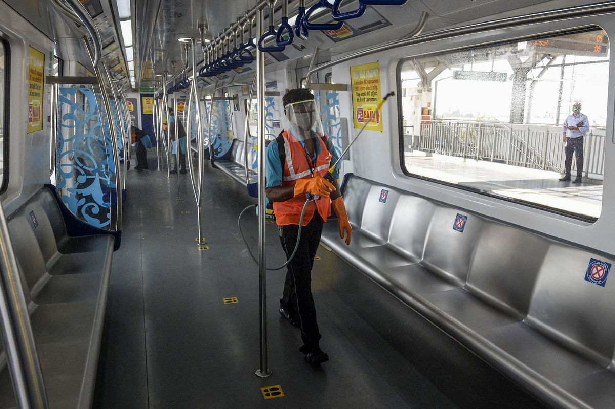 A worker sanitises a carriage of a commuter train after passengers got out following the resumption of metro services in Hyderabad. Credit: AFP