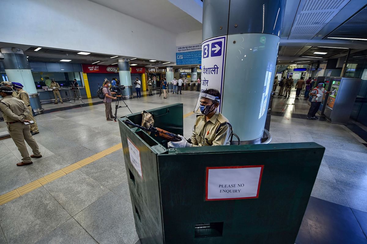 Security personnel stand guard at Rajiv Chowk station after Delhi Metro resumed services with curtailed operation of the Yellow Line, amid the ongoing coronavirus pandemic, in New Delhi. Credit: PTI