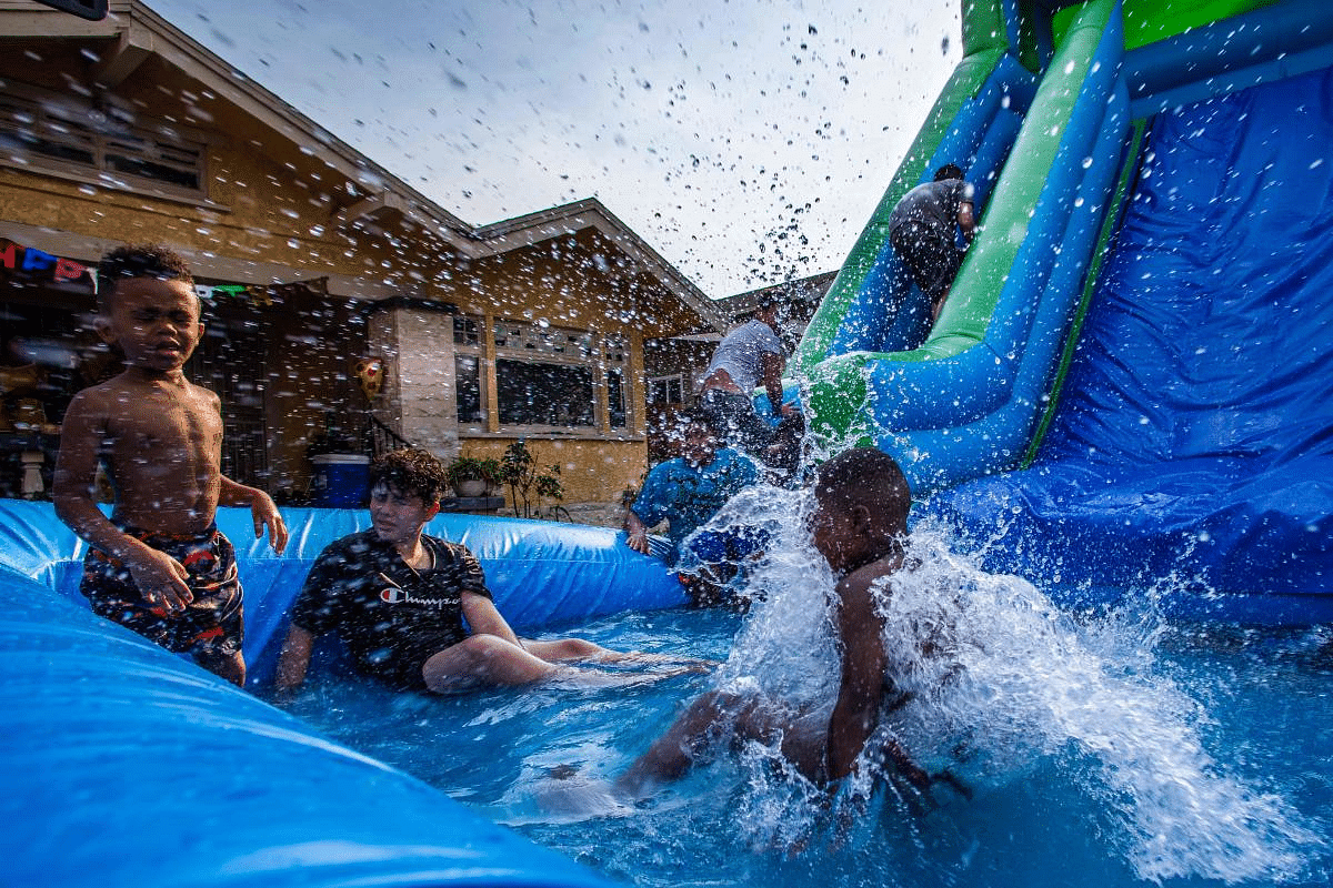 Children play in a swimming pool placed outside a house in South Los Angeles, to celebrate a birthday on the second day of the Labor Day weekend amid a heatwave in Caifornia. Credit: AFP Photo