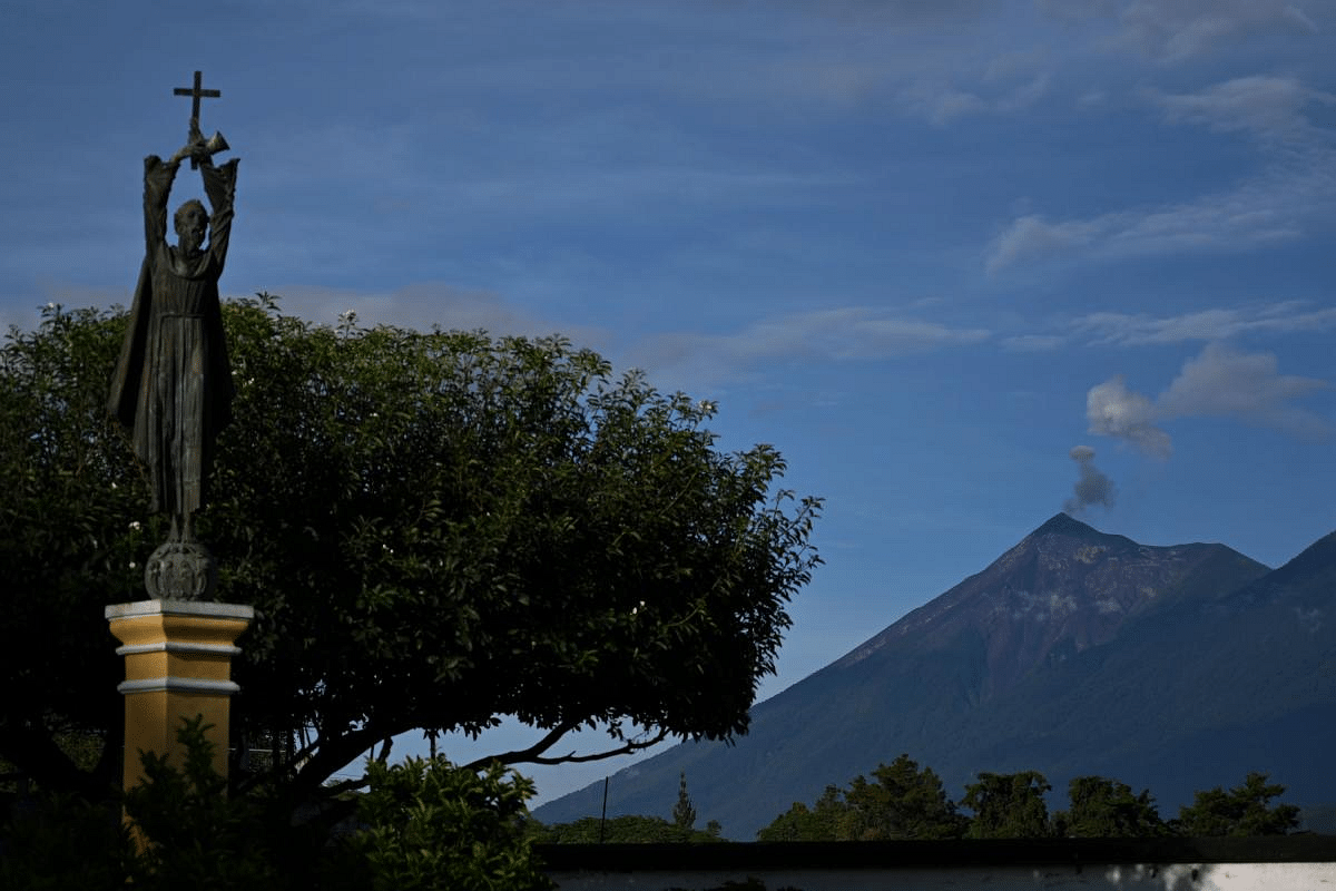 The Fuego Volcano spews ash as seen from Antigua Guatemala, Sacatepequez Departament, 45 km southeast of Guatemala City on September 6, 2020. - Since the economic reopening a month ago, the colonial city of Antigua, a Cultural Heritage of Humanity, is receiving local visitors under strict hygiene measures to avoid coronavirus contagion. But the city is waiting for the reopening of the international airport and borders to see the arrival of foreign tourists, its main income. Credit: AFP Photo