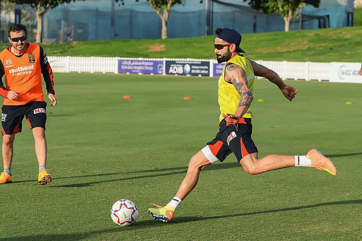 RCB captain Virat Kholi plays football during a practice session ahead of the Indian Premier League in Dubai.  Credit: PTI Photo