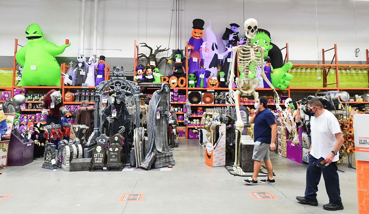 People walk past a display of Halloween items for sale at a home improvement retailer store in Alhambra, California. - Halloween and Christmas are two of the top spending holidays in the United States but retailers are spooked by Halloween this year due to the coronavirus pandemic. Credit: AFP Photo