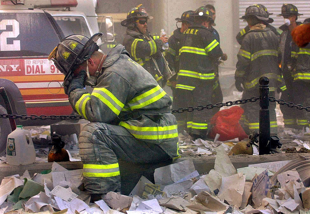 A firefighter breaks down after the World Trade Center buildings collapsed September 11, 2001 after two hijacked airplanes slammed into the twin towers in a terrorist attack that killed some 3,000 people. Credit: Getty Images