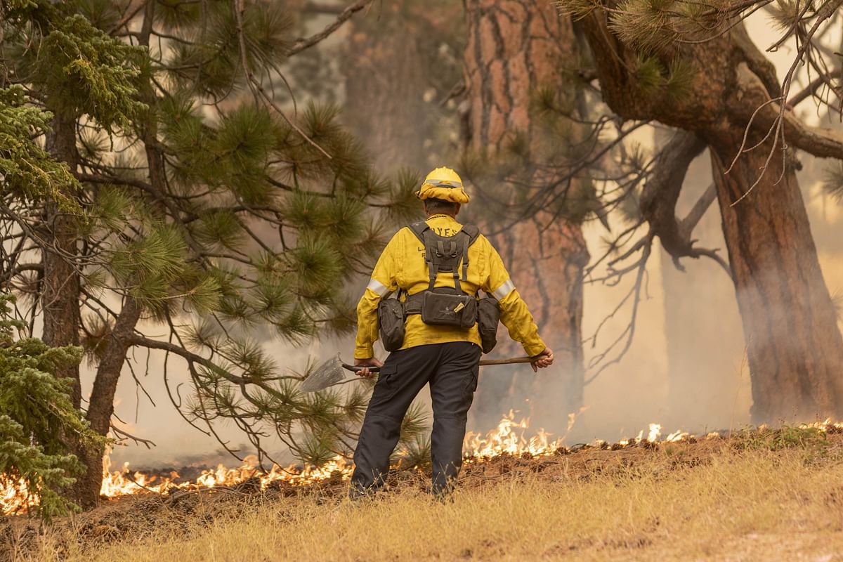 A firefighter keeps watch over creeping flames during the Bobcat Fire in the Angeles National Forest on September 11, 2020 in Monrovia. Credit: AFP Photo