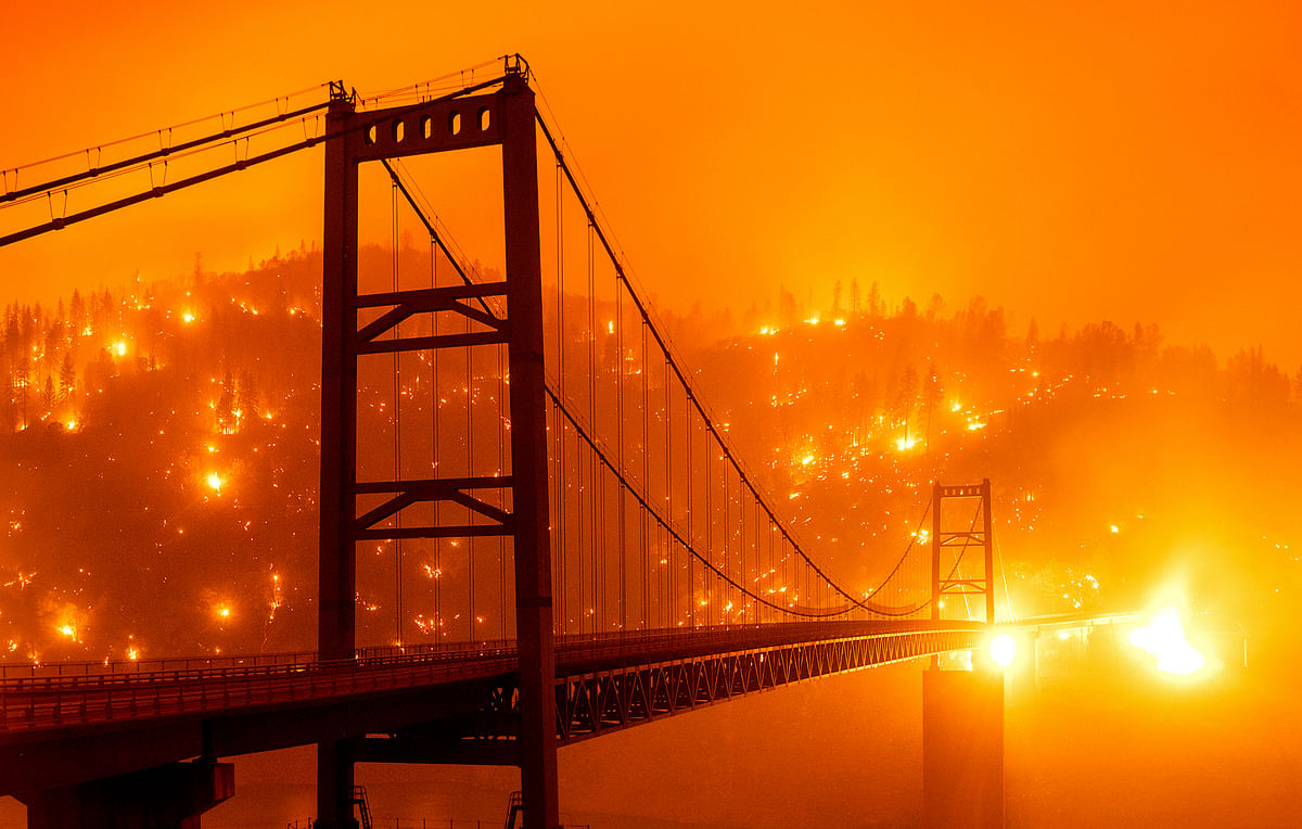 Embers light up a hillside behind the Bidwell Bar Bridge as the Bear Fire burns in Oroville on September 9, 2020. Credit: AP Photo