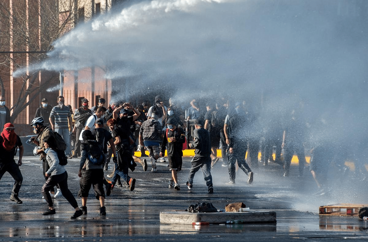 Demonstrators clash with riot police during a protest against Chilean President Sebastian Pinera's government in Santiago. Credit: AFP Photo