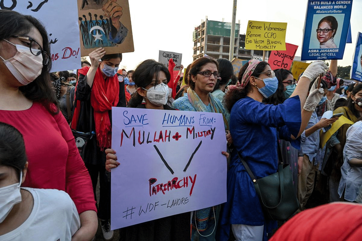 Human right activists hold placards as they march during a protest against an alleged gang rape of a woman, in Lahore. - Hundreds of women took to streets across Pakistan on September 12 protesting gruesome gang rape of a woman in front of her two children after her car ran out of fuel near the eastern city of Lahore late on September 9. Credit: AFP Photo