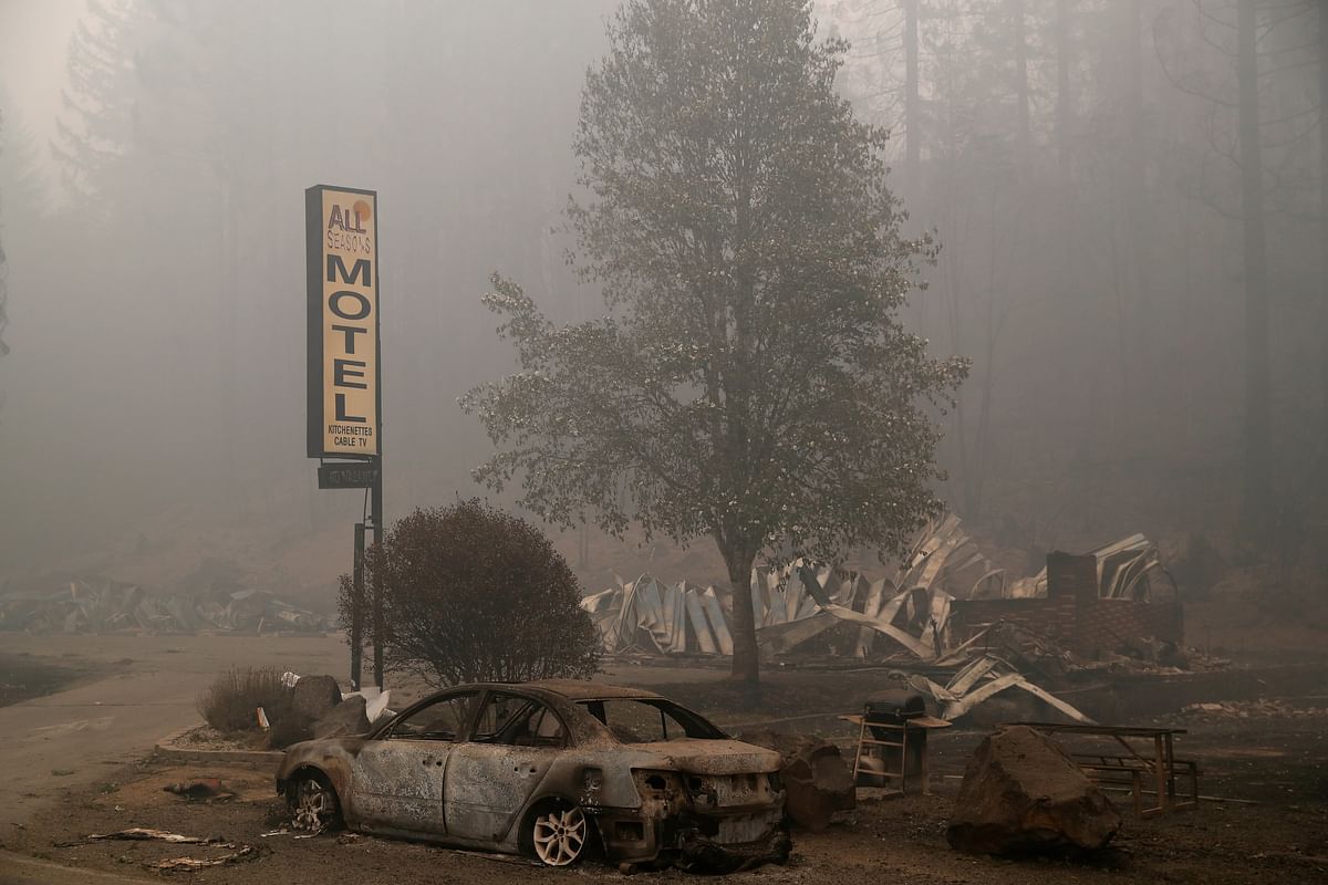 The remains of a fire damaged automobile and a motel sit in the aftermath of the Beachie Creek fire in Detroit, Oregon, US Credit: Reuters
