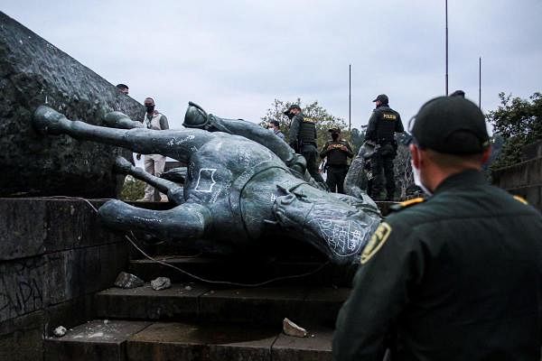 The statue of Sebastian de Belalcazar, a 16th century Spanish conqueror, lies on the ground after it was pulled down by indigenous in Popayan, Cauca department, Colombia. Credit: AFP Photo