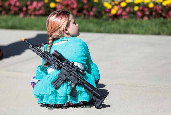 A young girl wears a toy weapon during a '2nd Amendment' rally at the Michigan State Capitol in Lansing, Michigan, U.S. Credit: Reuters Photo