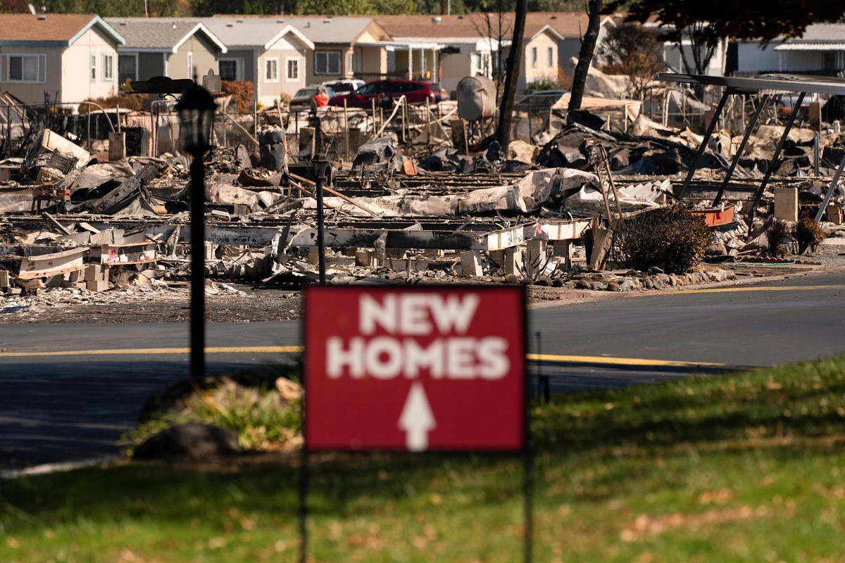 A sign advertising new homes stands in a neighborhood severely damaged by wildfire in Medford, Oregon, US. Credit: Reuters Photo