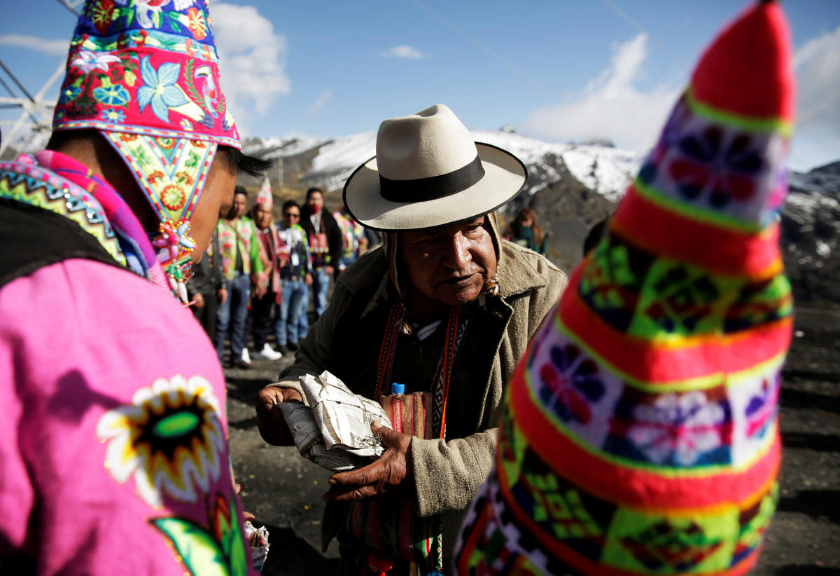 A witchdoctor takes part in a ceremony of an offering to ward off the outbreak of the coronavirus disease and call the prosperity in a new cycle of the agricultural calendar in the Bolivian highland region, La Cumbre on the outskirts of La Paz. Credit: Reuters Photo