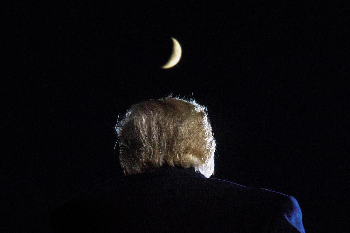 A moon is seen above US President Donald Trump during a campaign event at Toledo Express Airport in Swanton, Ohio. Credit: Reuters Photo