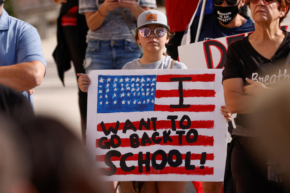 A student attends a rally with a coalition of business owners as they demonstrate for legal action against California governor Gavin Newsom over coronavirus shutdowns in San Diego. Credit: Reuters Photo