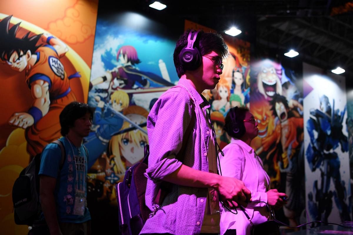 People play video games during the Tokyo Game Show in Makuhari, Chiba Prefecture. The exhibition, which opens on September 23, 2020 in an online format, showcases Japanese video games and is still regularly thronged by enthusiastic gamers, attracting more than 200,000 people over four years on average in recent years. Credit: AFP Photo