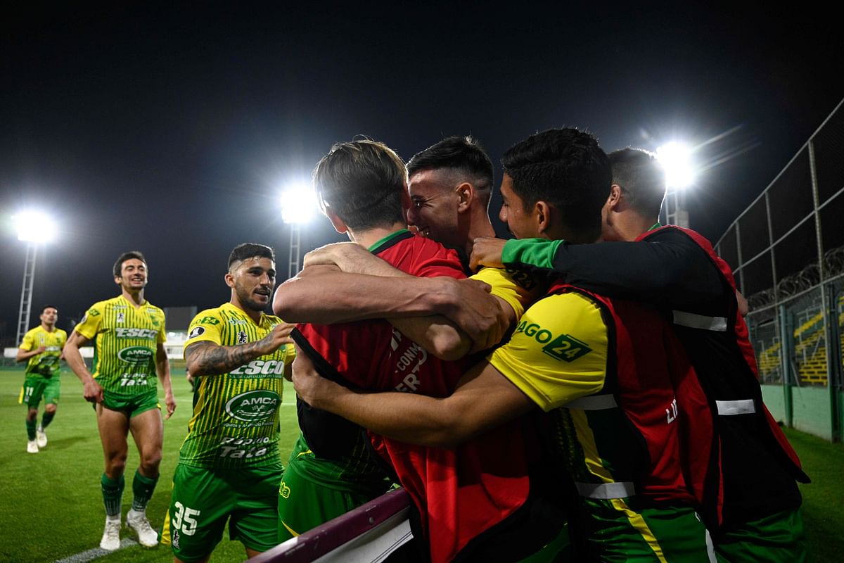 Players of Argentina's Defensa y Justicia celebrates after teammate Braian Romero (covered) scored against Paraguay's Olimpia during their closed-door Copa Libertadores group phase football match at the Norberto Tito Tomaghello Stadium in Buenos Aires, on September 23, 2020. Credit: AFP