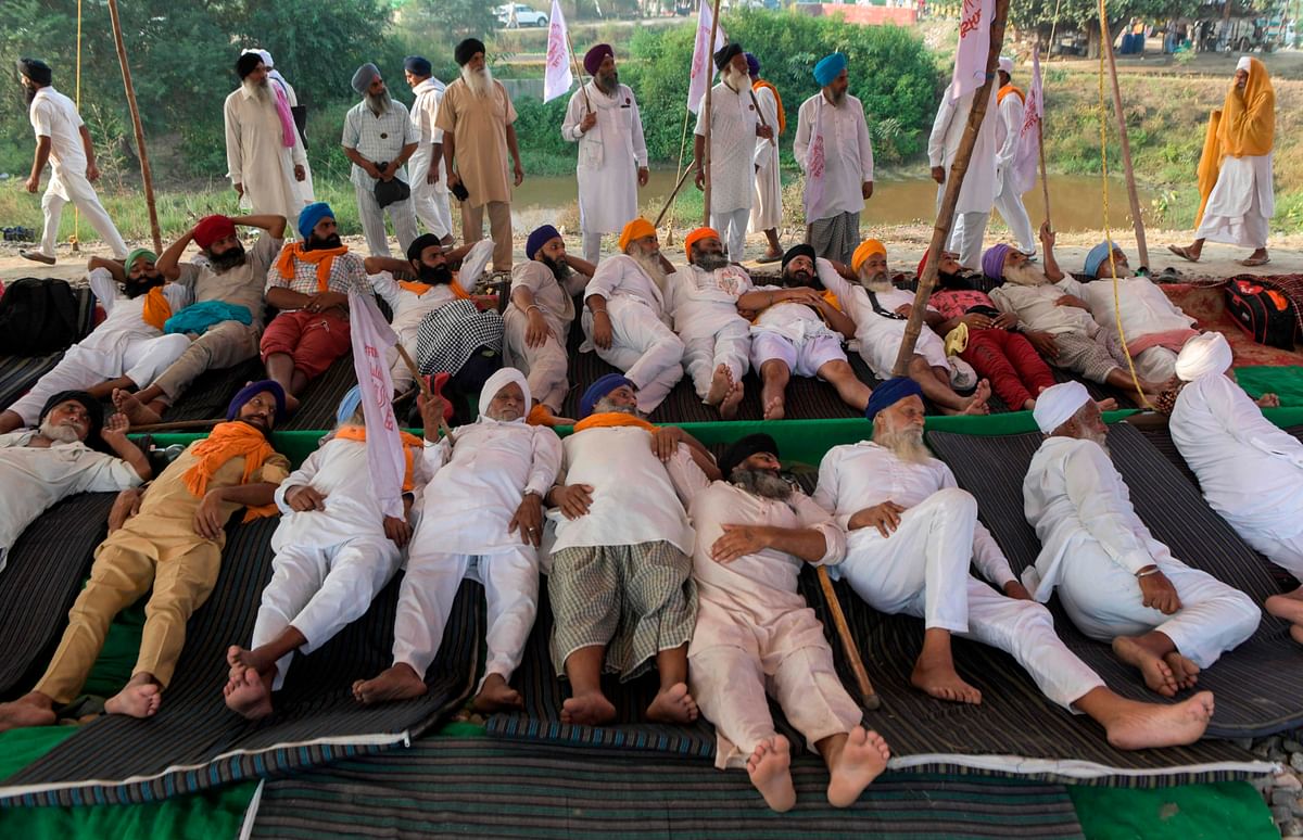 Farmers block train tracks during a nationwide farmers' strike following the recent passing of agriculture bills in the Lok Sabha (lower house), at Devi Dasspura village some 25 kms from Amritsar. Credit: AFP