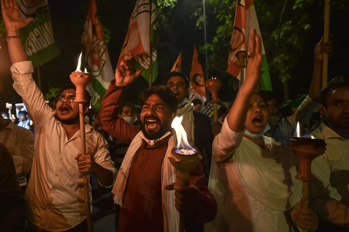 Indian Youth Congress (IYC) activists participate in a torch procession during a protest against farmers' bills, in New Delhi. Credit: PTI