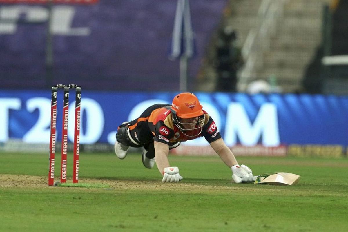 Sunrisers Hyderabad captain David Warner dives to get into the crease during the IPL 2020 cricket match against Delhi Capitals, at Sheikh Zayed Stadium, Abu Dhabi. Credit: PTI Photo