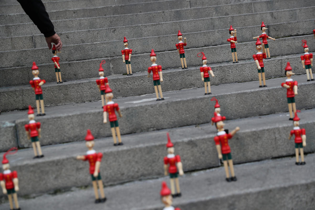 A street seller places Pinocchio models, as Chile eases some of the lockdown measures put in place during the coronavirus outbreak, in Santiago, Chile. Credit: Reuters Photo