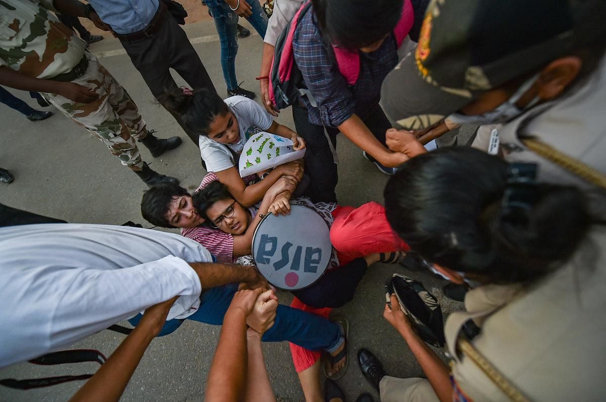 Members of All India Students Association (AISA) and Bhim Army detained by police during a protest against the death of a Dalit woman who was gang-raped in Hathras (UP), in New Delhi. Credit: PTI