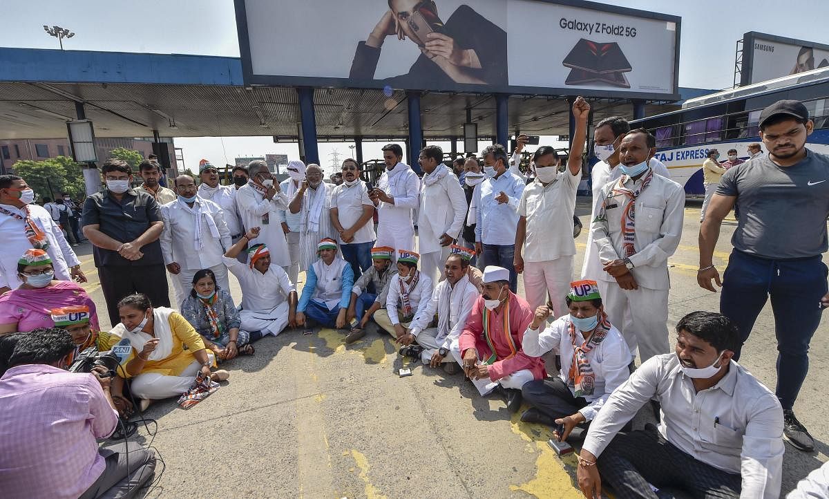 Congress supporters hold a dharna at DND toll, where security has been enhanced to check the movement of people, in New Delhi, Thursday. Credit: PTI Photo