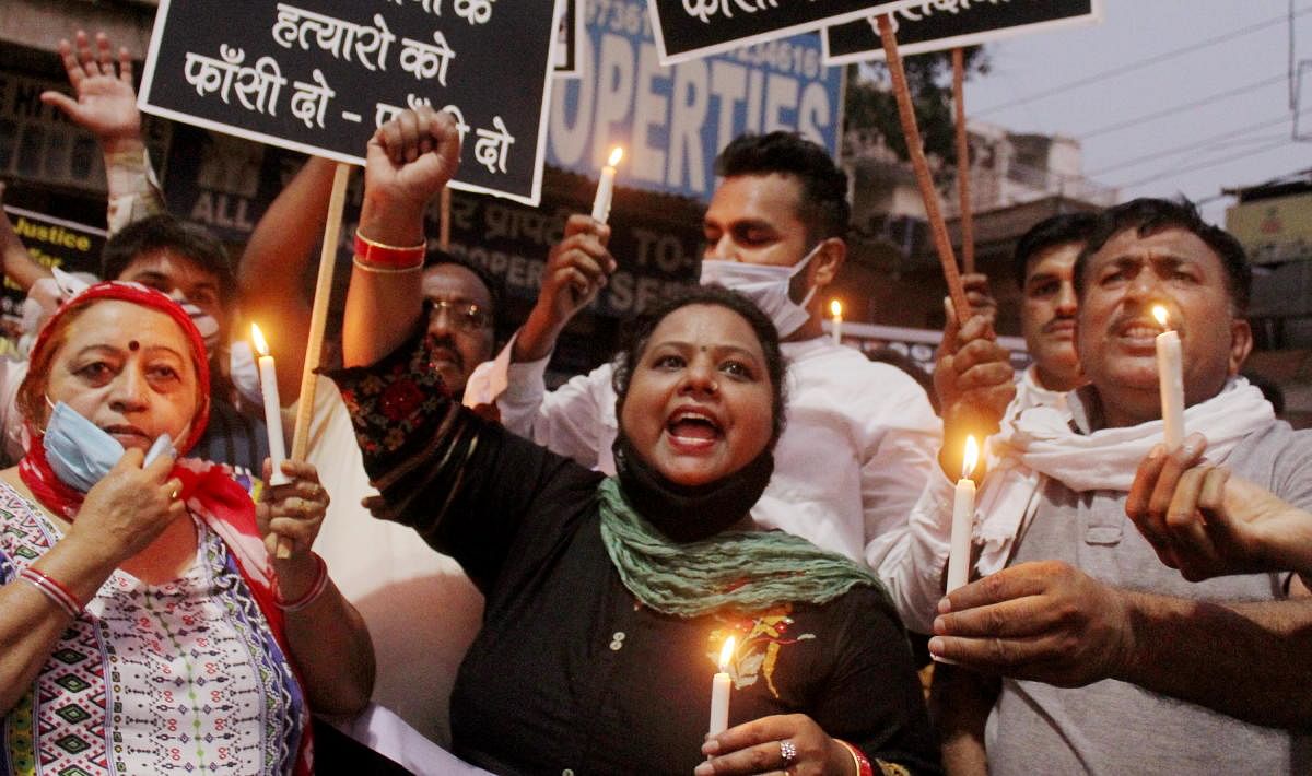  Residents and many social organisations members hold a candlelight protest demanding justice for the Hathras victim, at Kabir Bhawan Chowk, in Gurugram. credit: PTI Photo