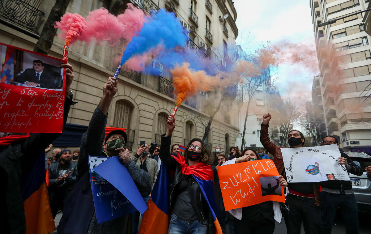 Members of the Armenian community in Argentina burn flares during a protest to support their country in light of the conflict with Azerbaijan, outside the Armenian embassy in Buenos Aires, Argentina. Credit: Reuters Photo
