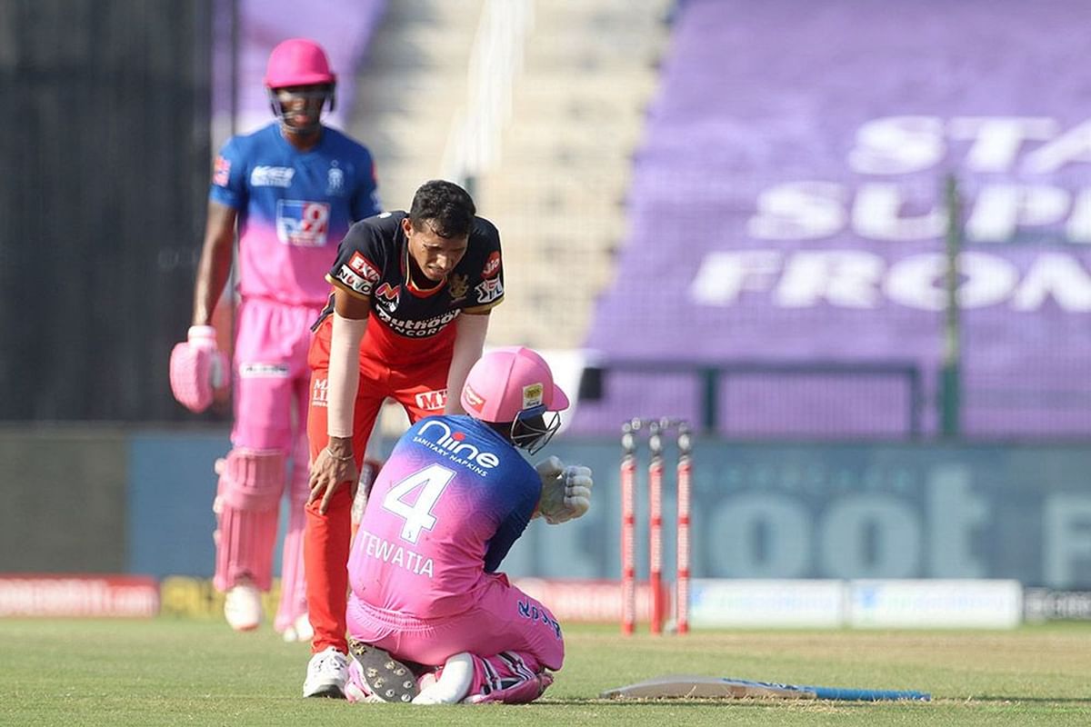 Navdeep Saini of Royal Challengers Bangalore check on Rahul Tewatia of Rajasthan Royals gets hit by a bowl he bowled. Credit: IPL official website (www.iplt20.com)