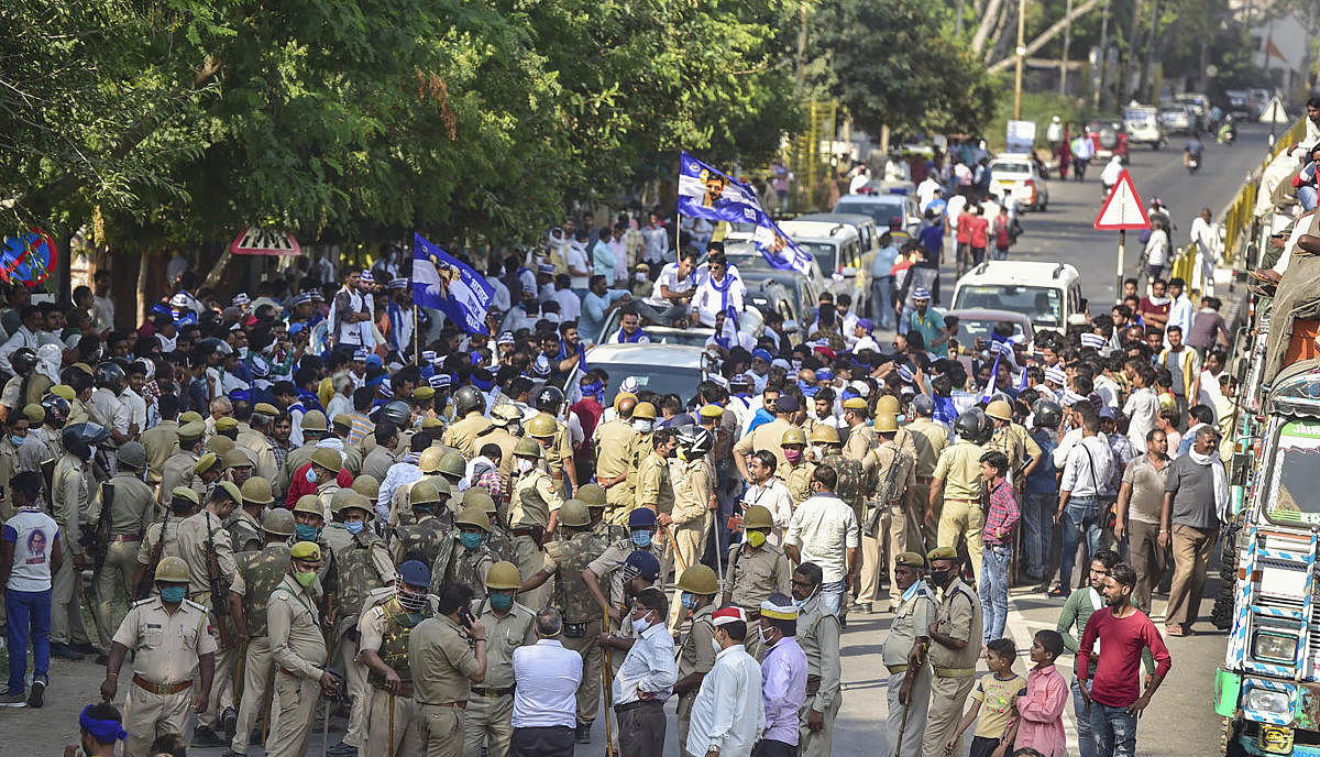 Police personnel try to stop Bhim Army President Chandrashekhar Azad and party workers while they were on their way to meet the family members of a 19-year-old Dalit woman who died after being allegedly gang-raped two weeks ago, at Sasni road in Hathras. Credit: PTI Photo