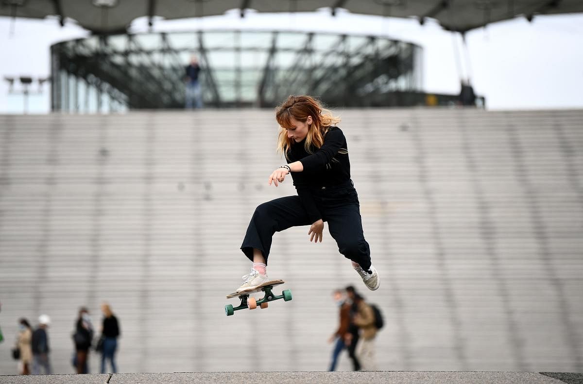 French longboarder specialised in freestyle longboard dancing, Cassandre Lemoine, practices on the esplanade of Paris' La Defense business district. Longboard dancing appeared in the early 2000s in the United States and today attracts many users on social networks. Credit: AFP Photo
